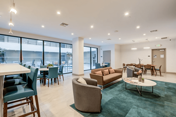 a living room with couches and chairs and tables